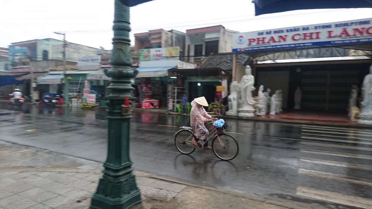 Those traditional hats – nón lá – defend against the rain as much as the sun